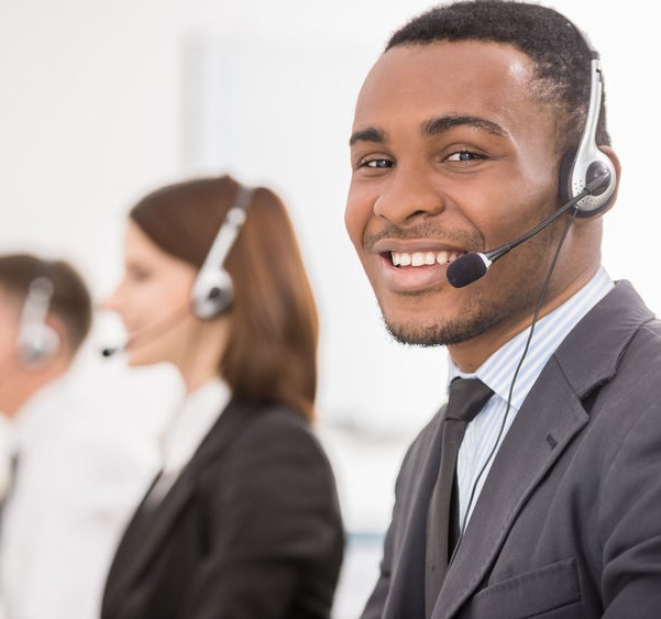 Group of agents sitting in line in a bright call centre.